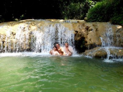 Gentle flow of Hieu Waterfall surrounded by limestone and forest in Pu Luong