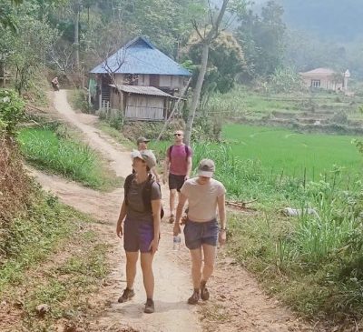Travelers trekking along rice terrace trails in Pu Luong Nature Reserve Vietnam