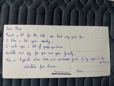 Handwritten postcard review from a French traveler after a private trekking experience in Pu Luong Vietnam
