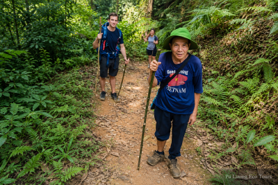 Local guide walking with guests on a private Northern Vietnam trekking tour