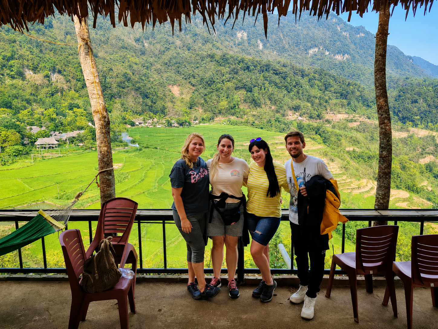 International travelers overlooking a rice valley during a Pu Luong trekking tour